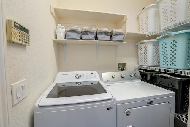 clothes washing area with laundry area and washer and clothes dryer