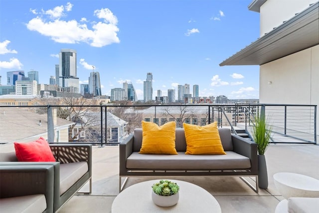 balcony with outdoor lounge area and a city view