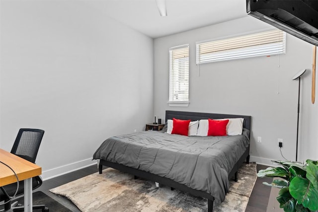 bedroom featuring baseboards and wood finished floors