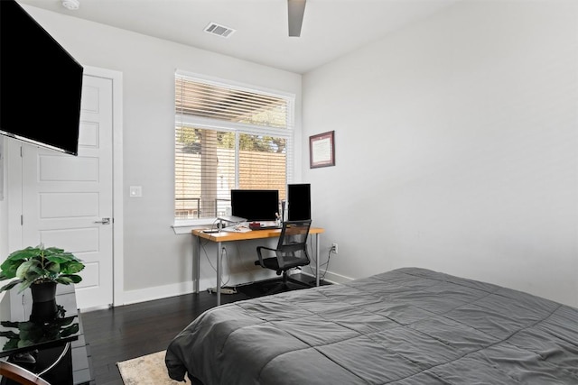 bedroom featuring ceiling fan, wood finished floors, visible vents, and baseboards