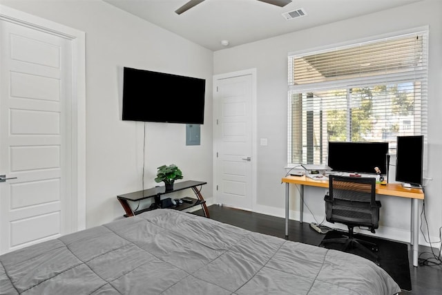 bedroom with a ceiling fan, wood finished floors, visible vents, and baseboards