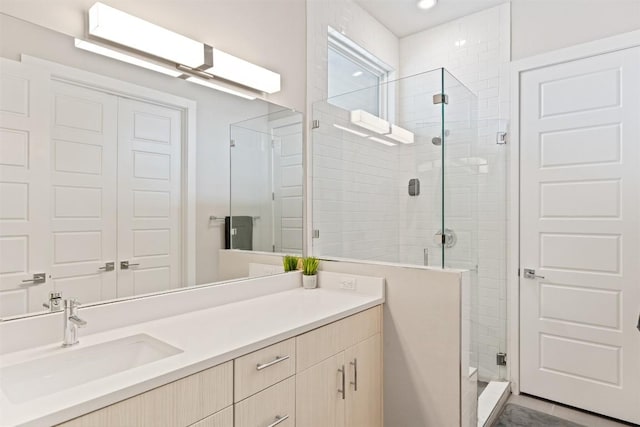 bathroom featuring a stall shower and vanity