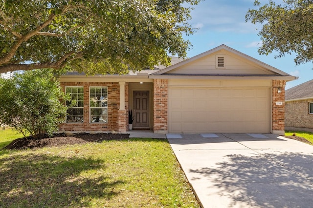 ranch-style home featuring a garage, a front yard, brick siding, and driveway