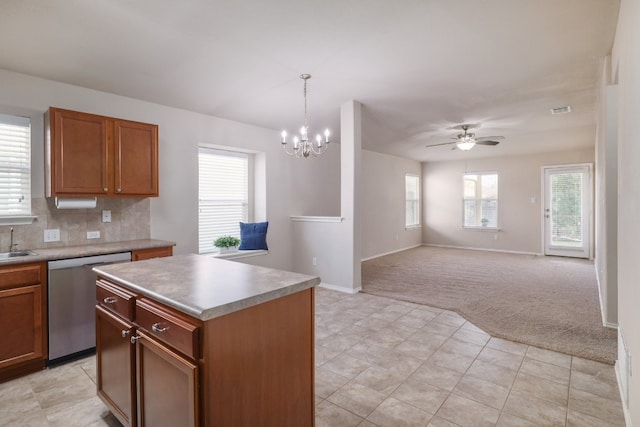 kitchen featuring light colored carpet, a sink, visible vents, stainless steel dishwasher, and tasteful backsplash