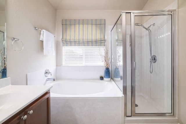 full bathroom featuring a garden tub, a shower stall, and vanity