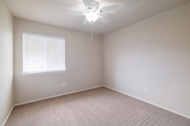 unfurnished room with a ceiling fan, carpet flooring, and baseboards