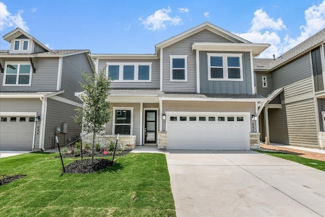 842 Nadal Path, Round Rock, TX 78664 - view of front of home with a garage, driveway, board and batten siding, a front yard, and stone siding