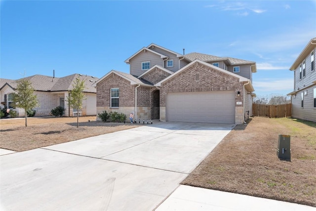 view of front of house with a garage, driveway, brick siding, and fence