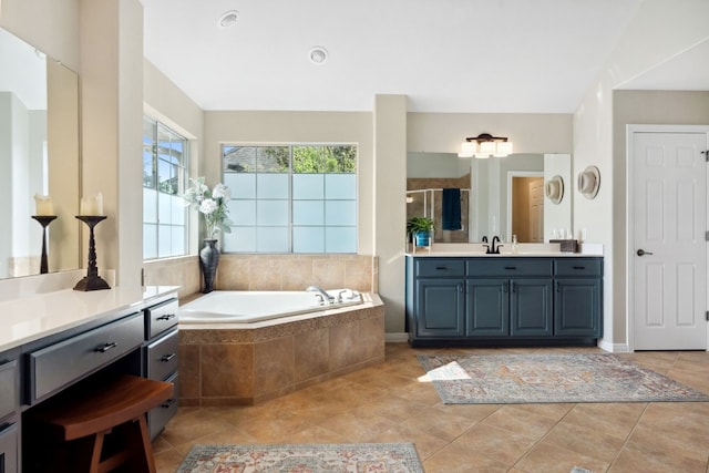 bathroom featuring vanity, a stall shower, tile patterned flooring, and a bath