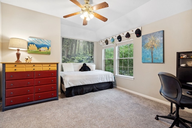 bedroom featuring carpet floors, vaulted ceiling, baseboards, and a ceiling fan