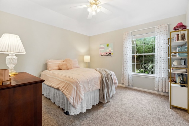 carpeted bedroom featuring ceiling fan and baseboards