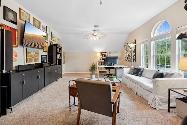 living area featuring lofted ceiling, a ceiling fan, visible vents, and light colored carpet