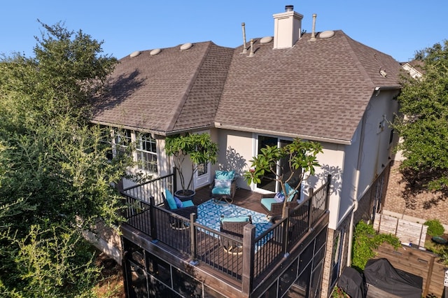 back of house with an outdoor hangout area, roof with shingles, a chimney, and stucco siding