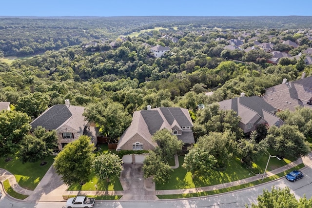 birds eye view of property with a residential view and a view of trees