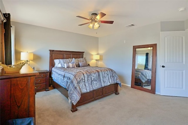 bedroom with a ceiling fan, light colored carpet, visible vents, and baseboards