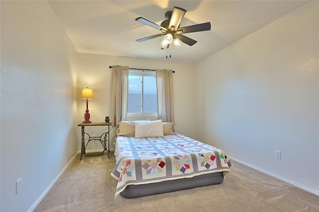 carpeted bedroom with ceiling fan and baseboards