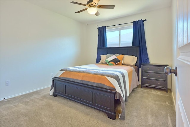 bedroom with baseboards, a ceiling fan, and light colored carpet