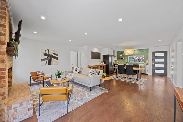 living area featuring dark wood-type flooring and recessed lighting