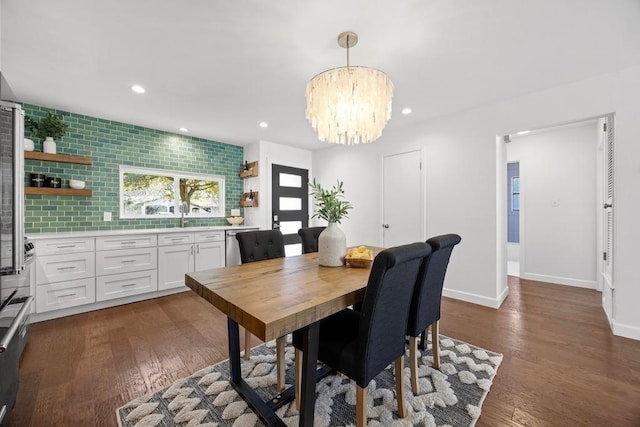 dining room featuring recessed lighting, dark wood finished floors, baseboards, and an inviting chandelier