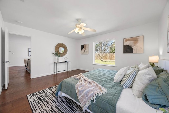 bedroom with a ceiling fan, baseboards, and wood finished floors