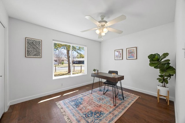 office area featuring a ceiling fan, baseboards, and wood finished floors