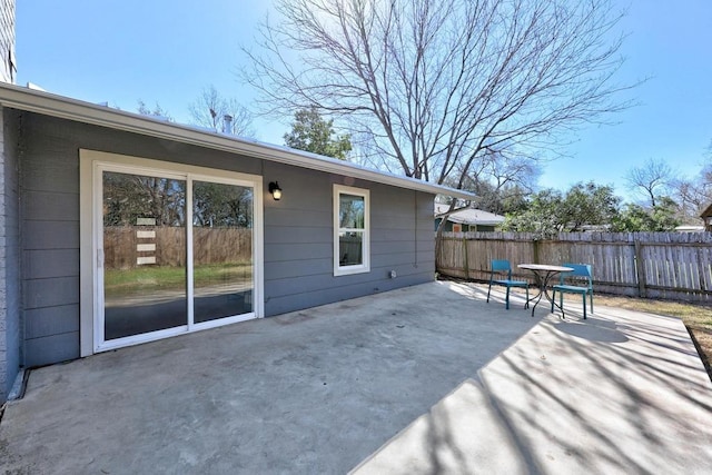 view of patio / terrace featuring fence