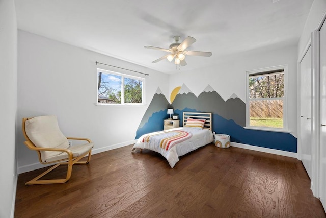 bedroom with a ceiling fan, a closet, baseboards, and wood finished floors