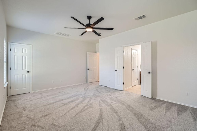 unfurnished bedroom with a ceiling fan, carpet flooring, visible vents, and baseboards