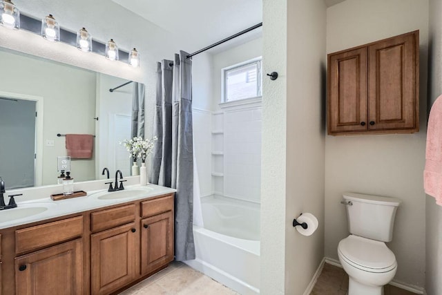 bathroom featuring toilet, shower / bath combination with curtain, tile patterned flooring, and a sink