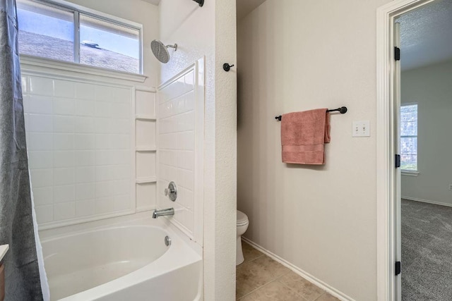 full bathroom featuring a textured ceiling, tile patterned flooring, toilet, shower / tub combo, and baseboards