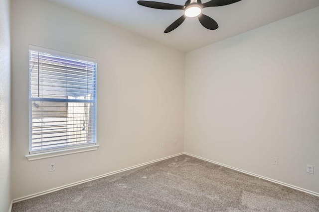 spare room featuring carpet, ceiling fan, and baseboards