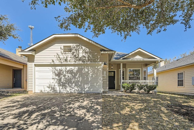 single story home with a garage, concrete driveway, and a porch