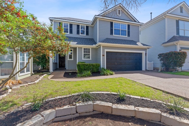 view of front of property featuring a garage, concrete driveway, a shingled roof, and a front lawn