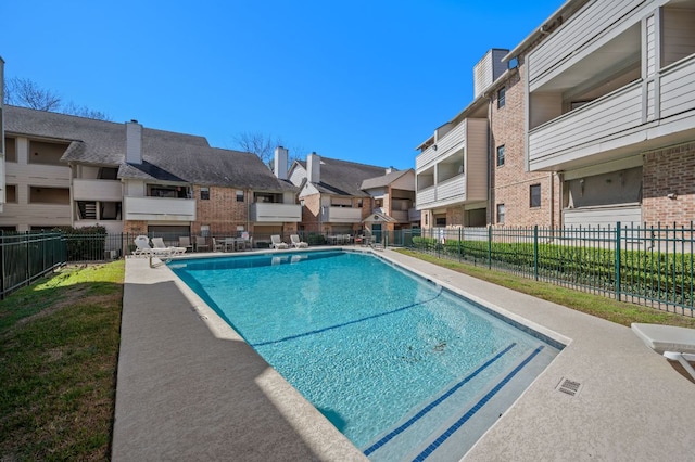 pool with a residential view and fence