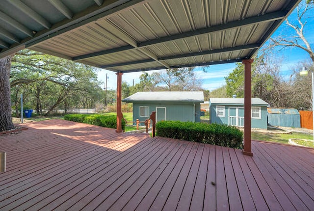 wooden terrace with an outbuilding and fence