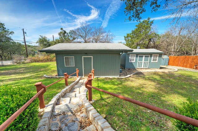 exterior space with an outdoor structure and fence