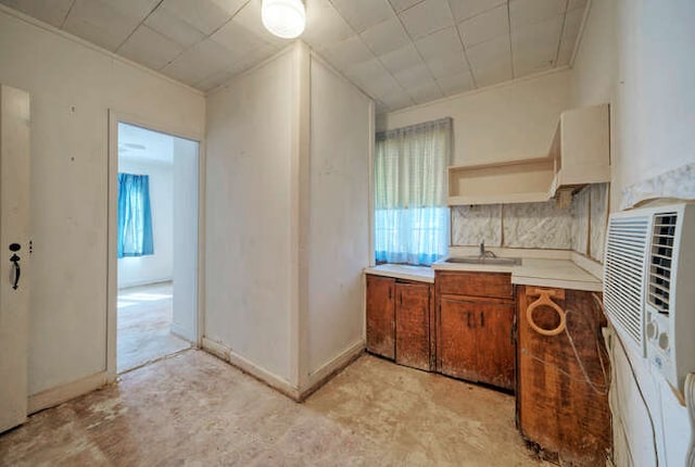 5600 Lakeview Dr, Austin, TX 78734 - kitchen with a sink, brown cabinets, unfinished concrete floors, open shelves, and light countertops