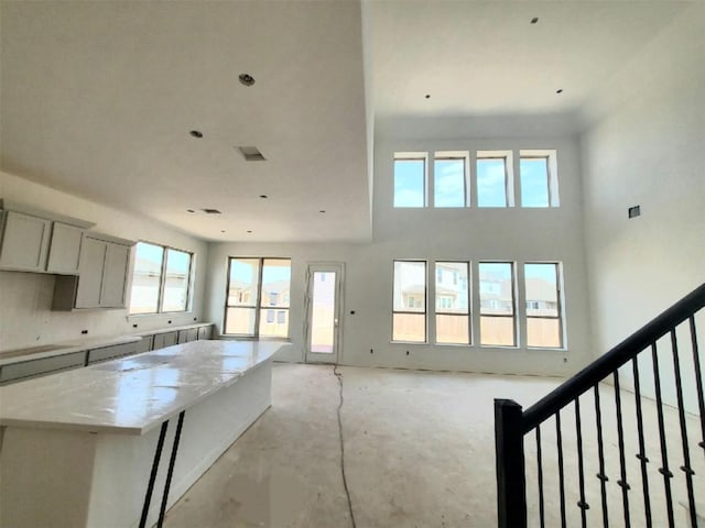 interior space with a high ceiling and a kitchen island