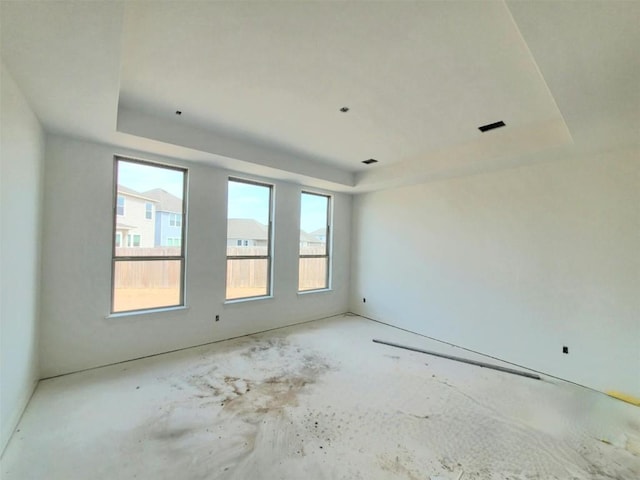 empty room featuring a raised ceiling