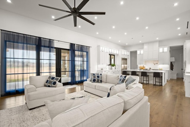 living area featuring ceiling fan, recessed lighting, and light wood-style floors