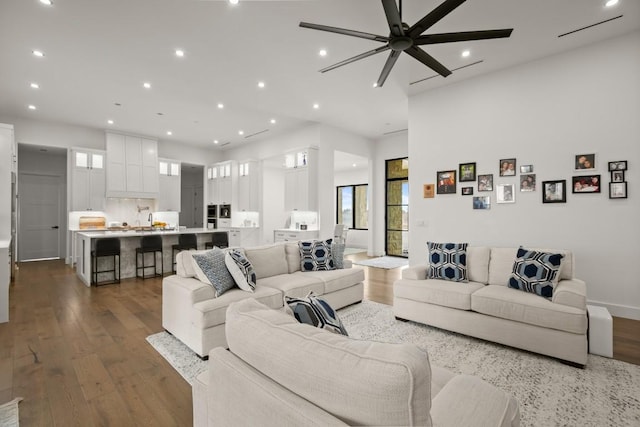 living room featuring recessed lighting, dark wood finished floors, and a healthy amount of sunlight