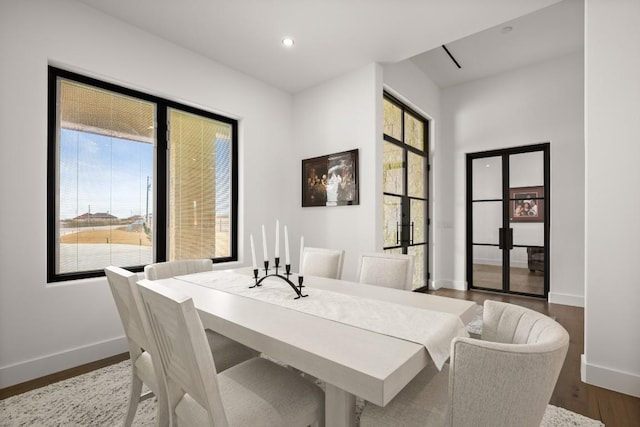 dining room with baseboards, a wealth of natural light, and wood finished floors