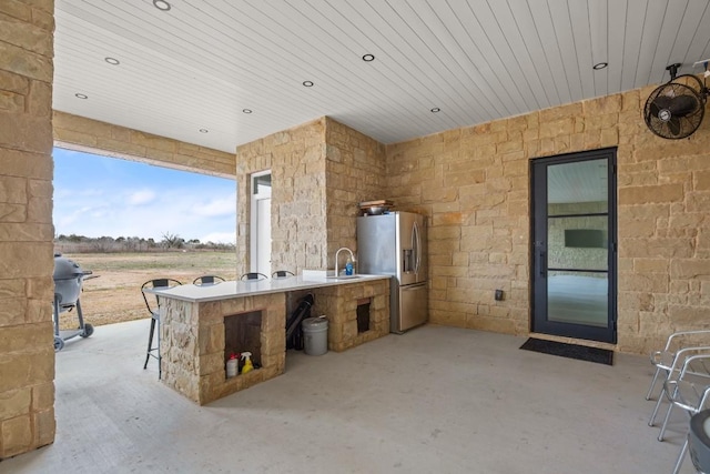 view of patio with a sink and exterior kitchen