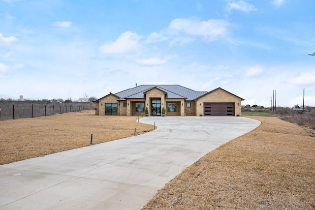 view of front facade with a standing seam roof, stone siding, a front lawn, and metal roof