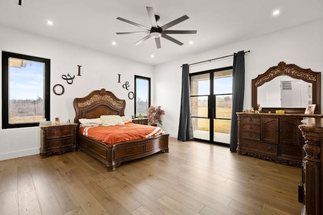 bedroom with recessed lighting, light wood-style flooring, and access to exterior