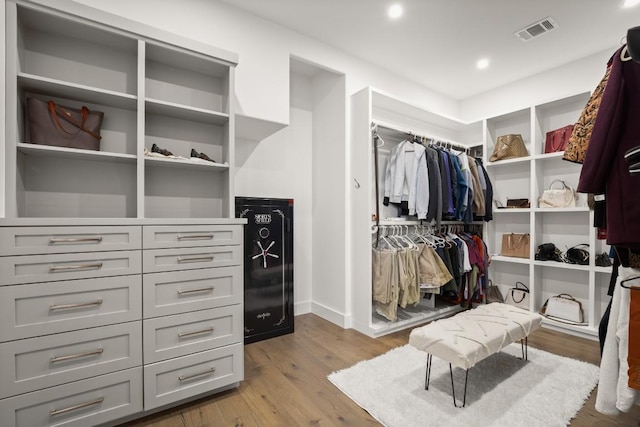 walk in closet featuring visible vents and wood finished floors