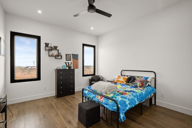 bedroom featuring recessed lighting, wood-type flooring, and baseboards