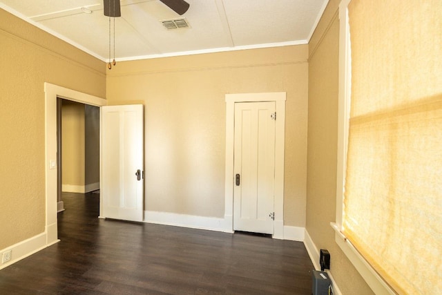 626 Saint Vincent St, Gonzales, TX 78629 - empty room with dark wood finished floors, ornamental molding, and a ceiling fan