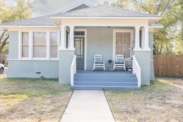 626 Saint Vincent St, Gonzales, TX 78629 - view of front facade with roof with shingles, brick siding, crawl space, a porch, and stucco siding
