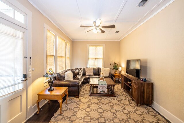 626 Saint Vincent St, Gonzales, TX 78629 - living area featuring a ceiling fan, baseboards, plenty of natural light, and crown molding